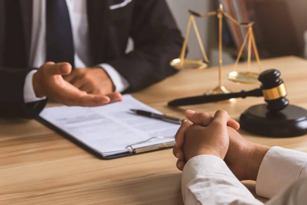 Workers’ compensation lawyer meeting with an injured client at a desk to discuss a workplace injury claim in Abbeville