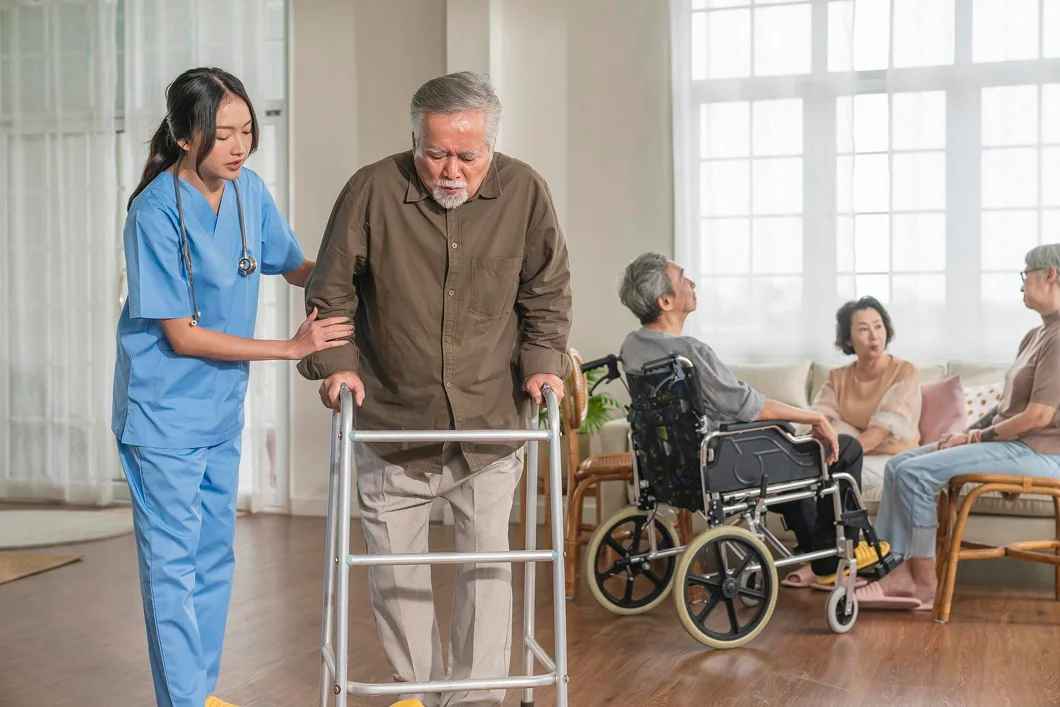 A nurse helping an elderly patient in a nursing home.