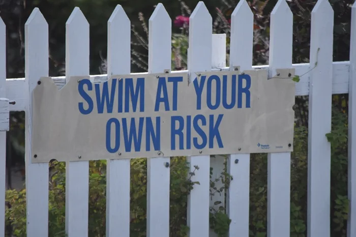 A warning sign on a premises, showing the "assumption of risk" that people may take in areas where slips and falls happen.