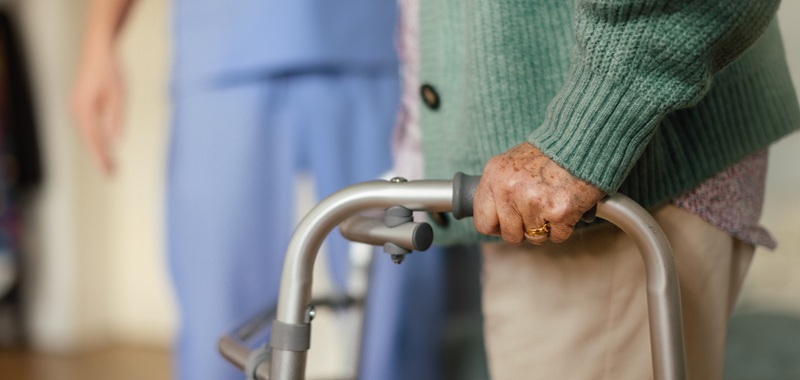 Close up of senior woman with walker at a nursing home.