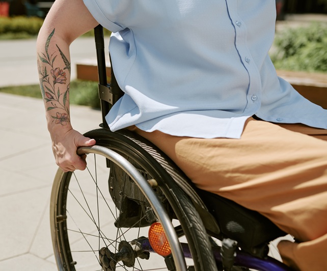 Closeup of a man using a wheelchair to get himself around. He suffered a SCI which made him unable to walk.