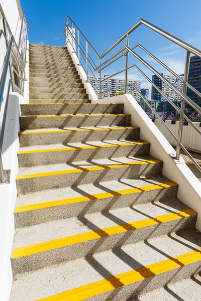 A cement staircase. Damaged stairways or handrails can pose a hazard on someone's property.